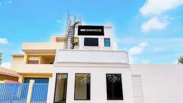 A two-story building with a sign that reads 'TOWNHOUSE' on the top.