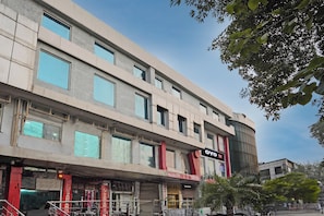 A multi-story hotel with a flat facade, large windows, and a sign for 'OYO Hotel One'. - Hotel O One Hotel (Ghaziabad)