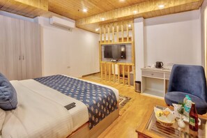 A bedroom with a bed, a desk, a chair, and a television. - The Zima Resort (Manali)