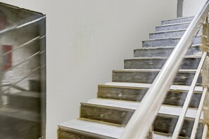 A staircase with metal handrails and steps. - Collection O by OYO One Hotel (Ghaziabad)