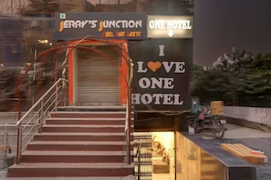 A hotel entrance with a staircase leading up to a closed door, a sign above advertising 'ONE HOTEL,' and a sign below stating 'I LOVE ONE HOTEL.' - Collection O by OYO One Hotel (Ghaziabad)