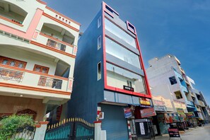 A multi-story building with a prominent sign for 'OYO Hotel'. - Hotel O by OYO S L N Grand (Hyderabad)