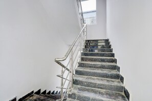 A staircase with metal railings and a skylight above. - Hotel O by OYO Living Tree In (Hyderabad)