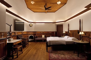 A hotel room with a bed, desk, chair, and a large mirror. - Miln Town by Zari (Coonoor)