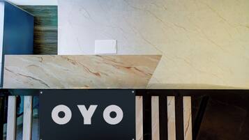 A reception desk with a sign that reads 'OYO'.