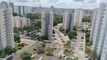 A high-rise residential area with multiple apartment buildings, a parking lot, and a construction crane in the distance.