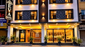 A hotel with a modern facade, large windows, and a welcoming entrance. - Eva Hotel (Zirakpur)