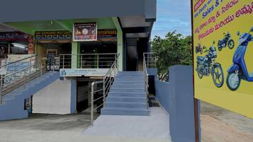 A multi-brand showroom with a staircase leading to the entrance.