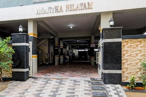 The entrance to a building with a tiled floor and a reception desk on the first floor. - Hotel O RR GRAND STAY (Hyderabad)