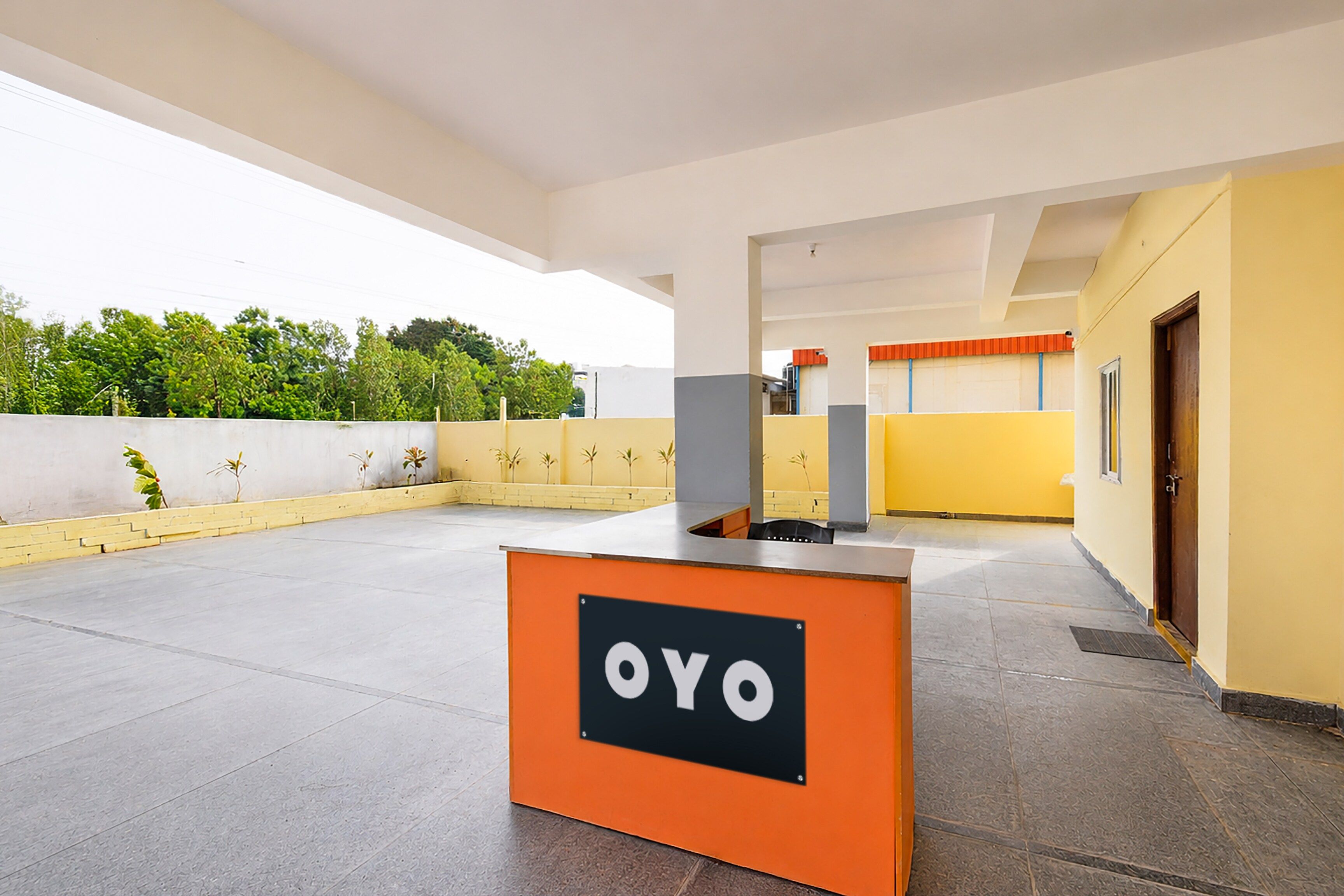 A reception area with a sign reading 'OYO' and a tiled floor.