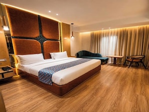 A modern hotel room with a large bed, a desk, and a chair. - Palette Hotel Maneraa by CheckIn (Tirupati)