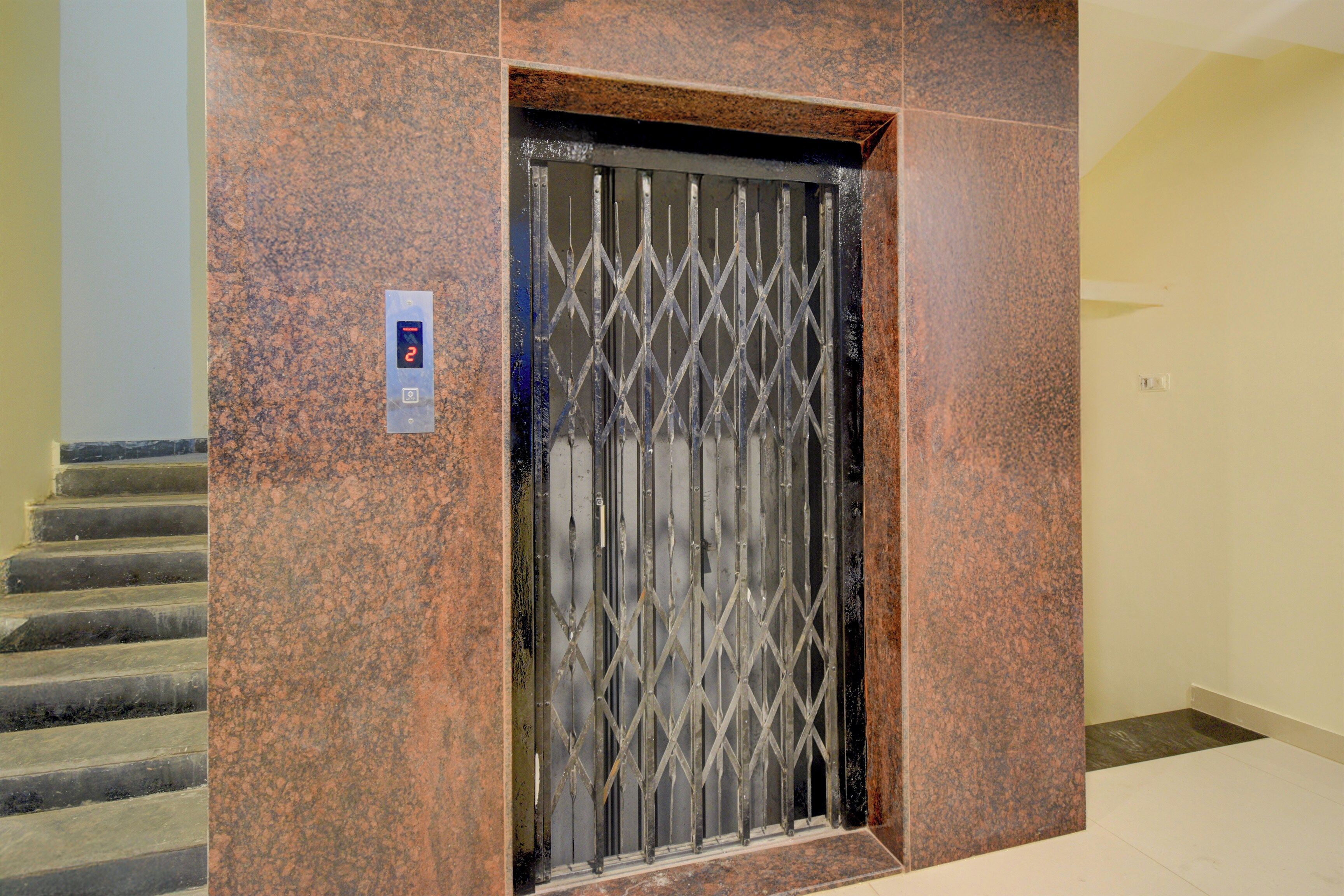Un ascensor con una puerta metálica, una pantalla digital y un panel de control.