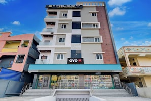 A multi-story hotel building with a prominent sign for 'Hotel Nivara' and 'GSK Heights' on the facade. - Super Hotel O Nivara (Hyderabad)
