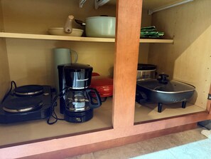 A kitchen with a coffee maker, a rice cooker, and a pressure cooker on the countertop. - Delightful 1-bedroom guesthouse in basement with private entry and free parking (Ellicott City)