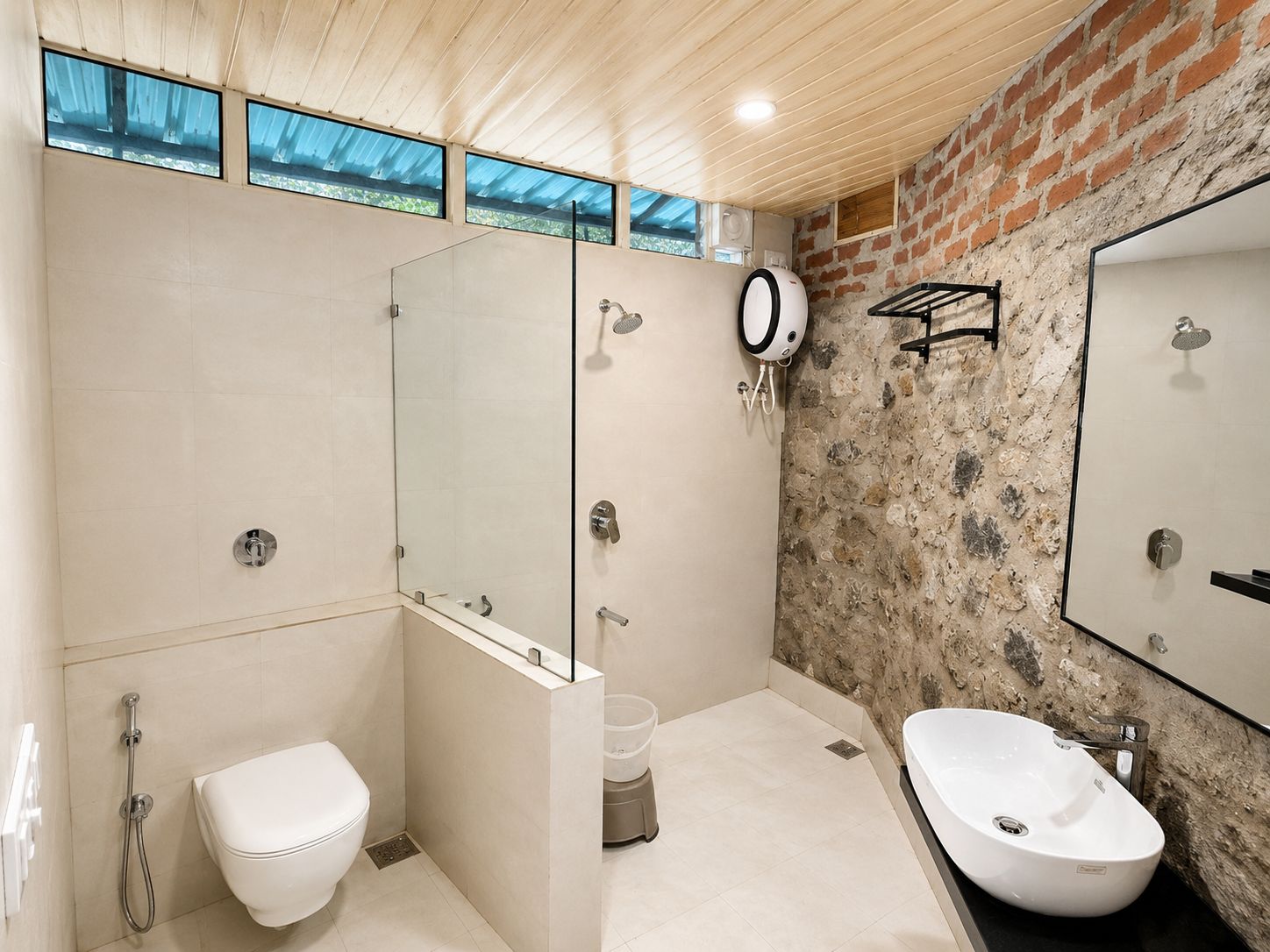 A modern bathroom with a shower, toilet, and sink.