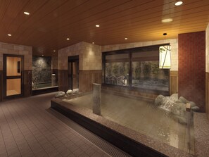 A spa area with a hot tub, stone walls, and wooden flooring. - Natural Hot Spring Matsubara no Yu (Rikuzentakata)