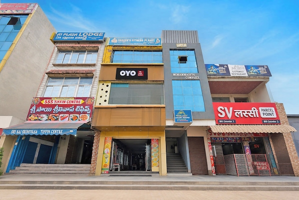 A multi-story building with various commercial establishments including a hotel, a fitness center, and a restaurant.