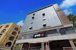 A modern building with a sign for 'OYO Hotel Sree Nirvi' and 'CodersMax' on the ground floor. - Hotel O Sree Nirvi (Hyderabad)
