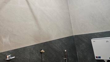 A bathroom with a shower, a toilet, and a sink.