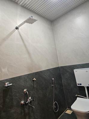 A bathroom with a shower, a toilet, and a sink. - SRG Hotel and Restruant (Borgaon)