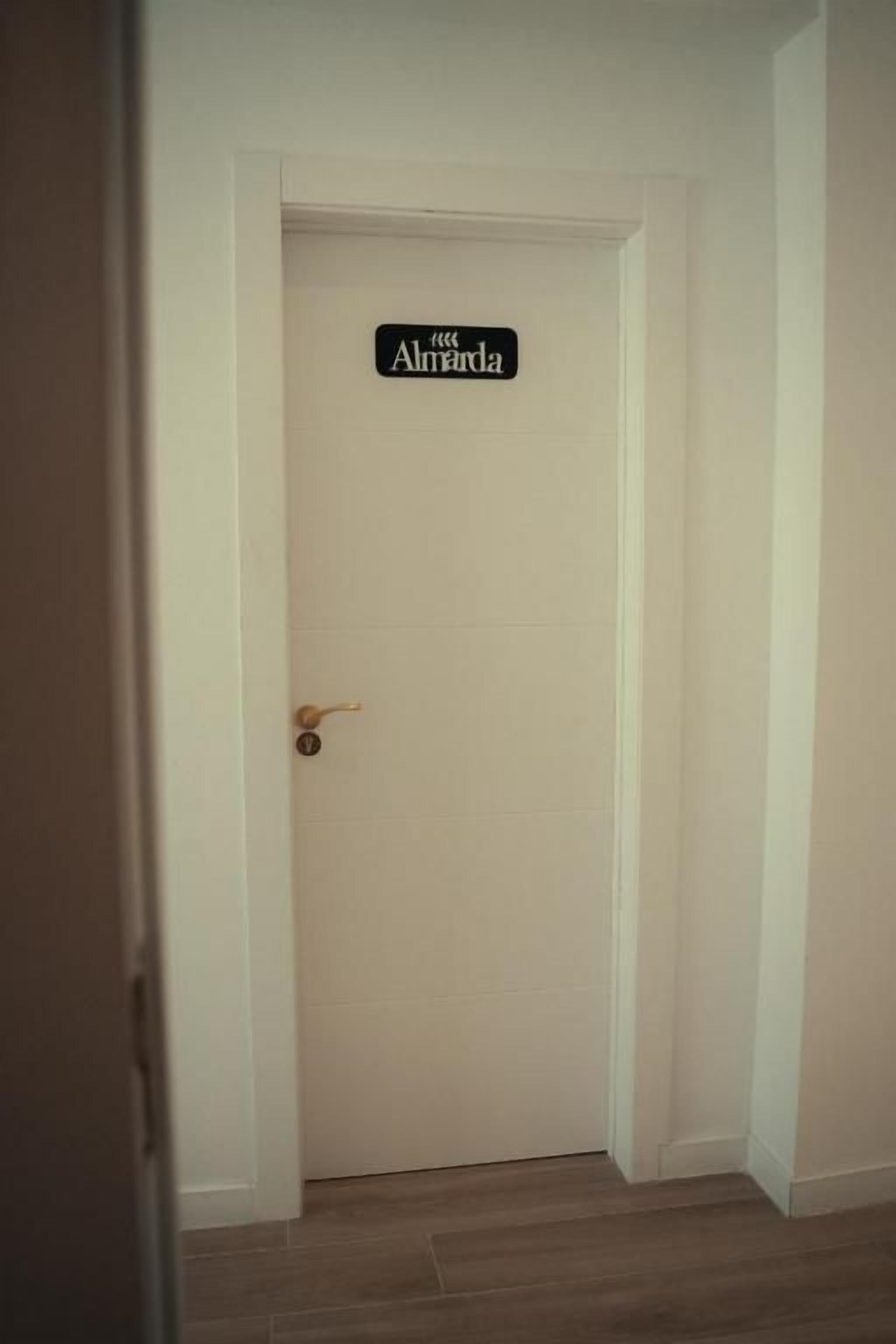 A closed white door with a sign above it.