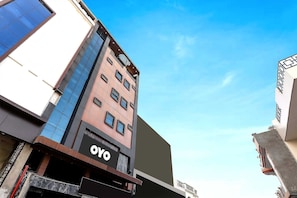 A multi-story building with a prominent 'OYO' sign on the ground floor, suggesting a hotel or commercial space. - Townhouse Hotel Vaishnavi Inn (Lucknow)