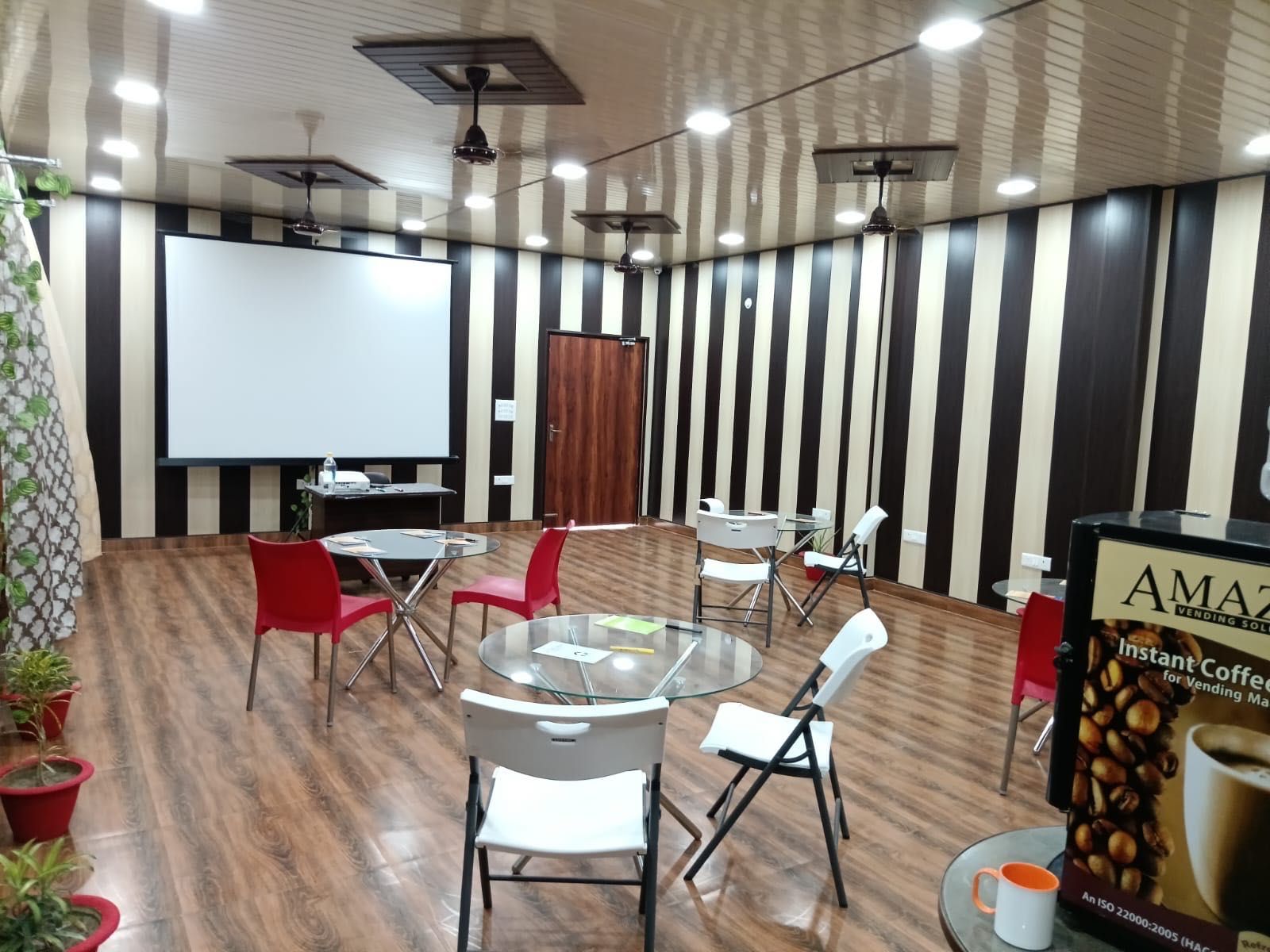 A conference room with a whiteboard, tables, and chairs.