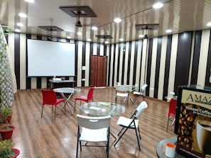 A conference room with a whiteboard, tables, and chairs. - Hotel O By OYO R K Residency SGPGI (Lucknow)