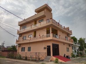 A multi-story residential building with balconies, a gated entrance, and a ramp leading to the main door. - Hotel O By OYO R K Residency SGPGI (Lucknow)