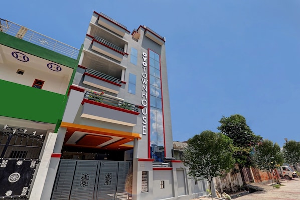 A multi-story building with a prominent 'OVOTOWNHOUSE' sign, a gated entrance, and a balcony with railings. - Townhouse swaroop inn (Lucknow)