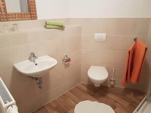 Ein Badezimmer mit Waschbecken, Toilette und Dusche.