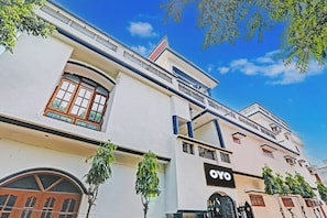 A multi-story building with a prominent 'OYO' sign, large windows, and a balcony. - Hotel O Shiva Grand (Lucknow)