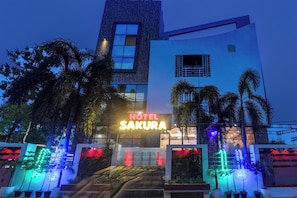 A hotel named 'Hotel Sakura' with a modern facade, large windows, and a signboard. - Townhouse Sakura (Lucknow)