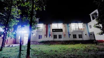 A building with a sign reading 'OYO TOWNHOUSE' at night.