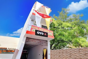 A hotel entrance with a sign for 'ROYAL INN OYO' and a visible air conditioning unit. - HOTEL O YASH ROYAL INN (Lucknow)