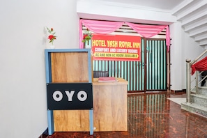 A hotel reception area with a sign for Hotel Yash Royal Inn, indicating comfort and luxury rooms available. - HOTEL O YASH ROYAL INN (Lucknow)