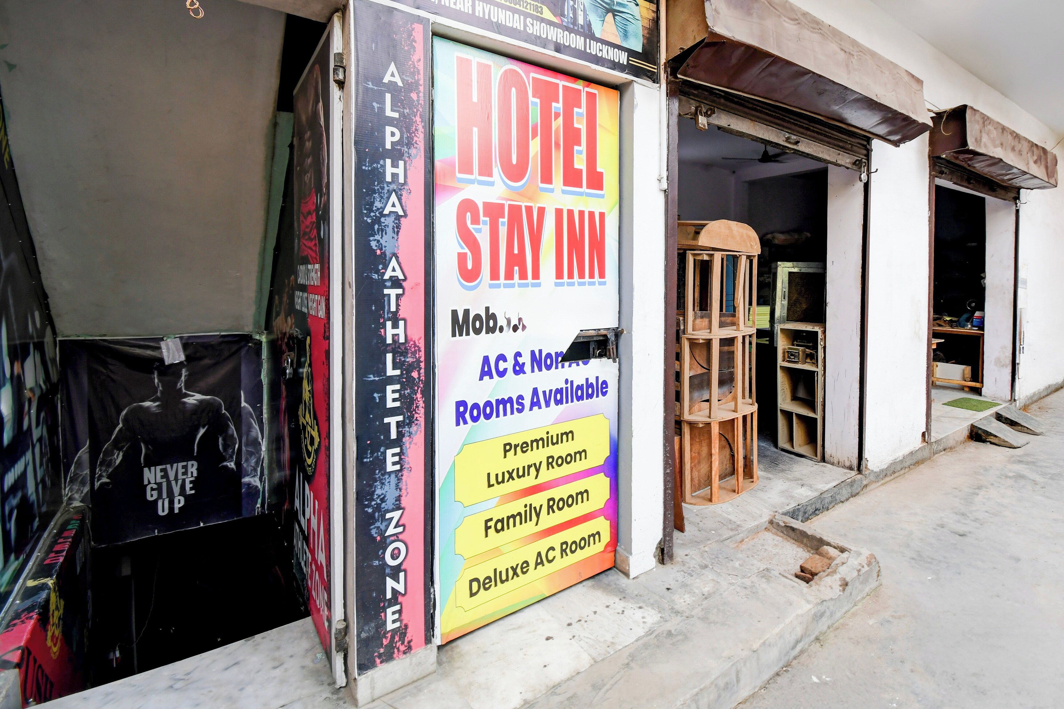 A hotel sign advertising various room types including a luxury room, family room, and deluxe AC room.