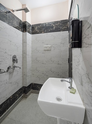 A bathroom with a white sink, a shower, and a mirror. - Hotel O PARK'S HOTEL (Moradabad)