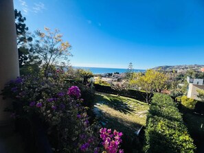 A garden with a view of the sea and buildings in the distance. - New Listing (Sanremo)
