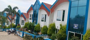 A row of modern, multi-story buildings with a consistent architectural style, featuring large windows and a blue and white color scheme.