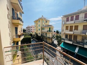 A residential area with multi-story buildings, balconies, and a clear sky. - New Listing (Sanremo)