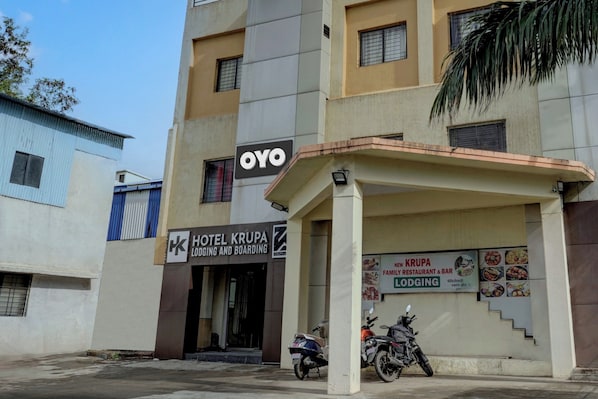 A building with a sign for 'Hotel Krupa' and a 'New Krupa Family Restaurant & Bar'. - Hotel O Krupa Lodge (Paud)