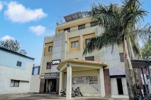 A multi-story building with a sign for 'OYO' and 'KRUPA HOTEL & BOARDING'. - Hotel O Krupa Lodge (Pune)