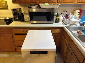 A kitchen with a microwave, coffee maker, and a white appliance, possibly a dishwasher or dryer, on the counter. - Clean large space in Upscale Stow. Near KSU, Akron U, Akron and Cuyahoga Valley. (Stow)