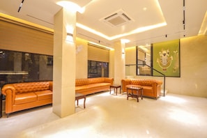 A modern interior with a sofa set, a small table, and a decorative wall piece. - OnlyStay DD Dham Prem Mandir, Vrindavan (Vrindavan)