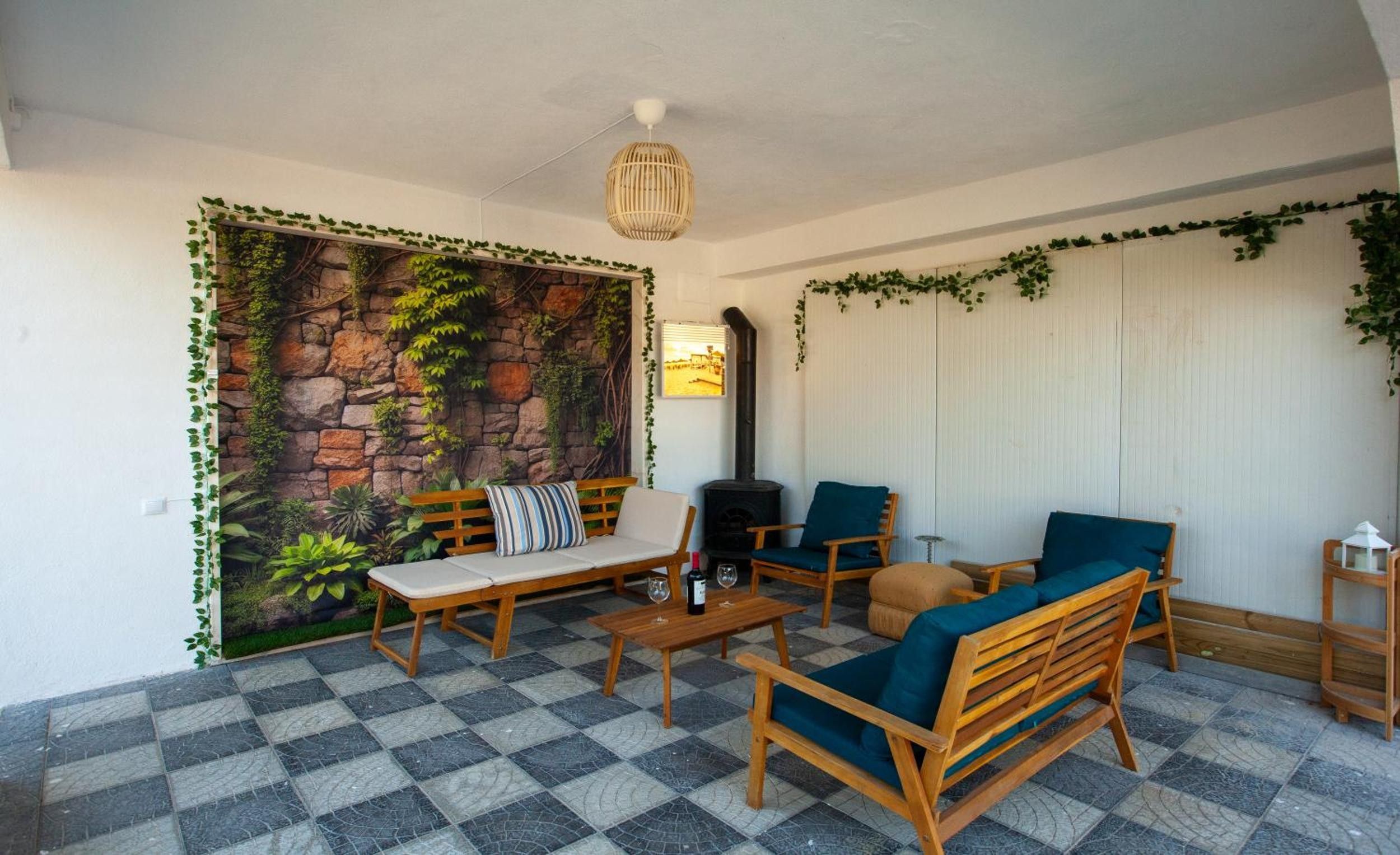 A cozy indoor seating area with a stone wall mural, a fireplace, and a checkered floor.