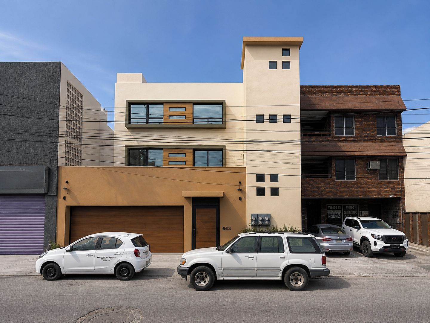 A modern building with a garage, a two-story structure, and a brick facade.
