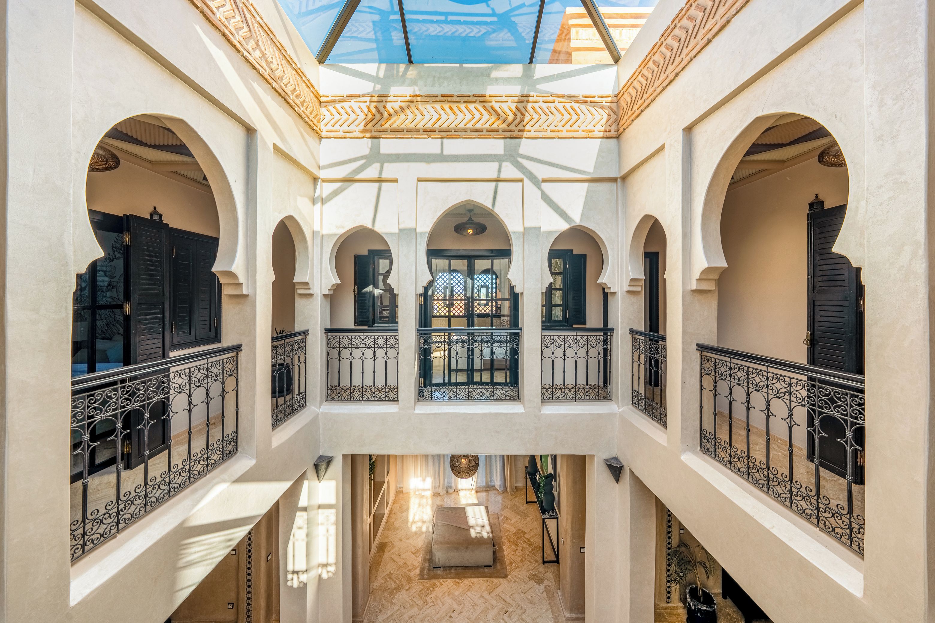 A multi-level interior with arched doorways and a central open space.