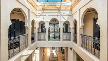 A multi-level interior with arched doorways and a central open space.