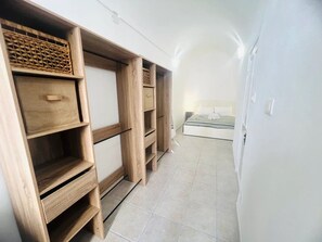 A bedroom with a bed, a wardrobe, and a built-in shelf unit. - New Listing (Sanremo)